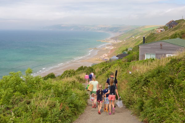 Whitsand Bay Beach featuring a coastal town and a beach as well as a family