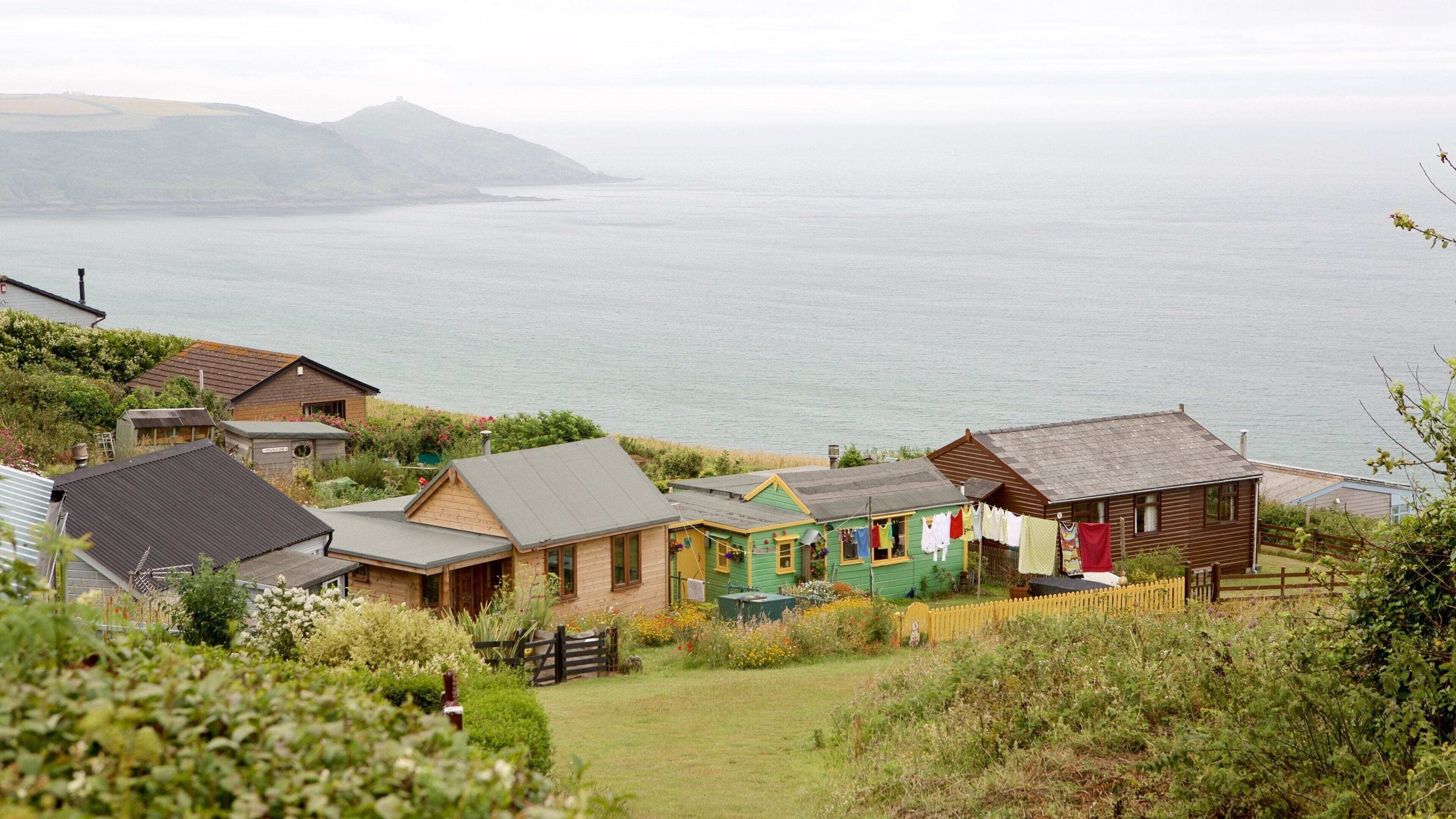Whitsand Bay Beach featuring mist or fog, a house and a coastal town