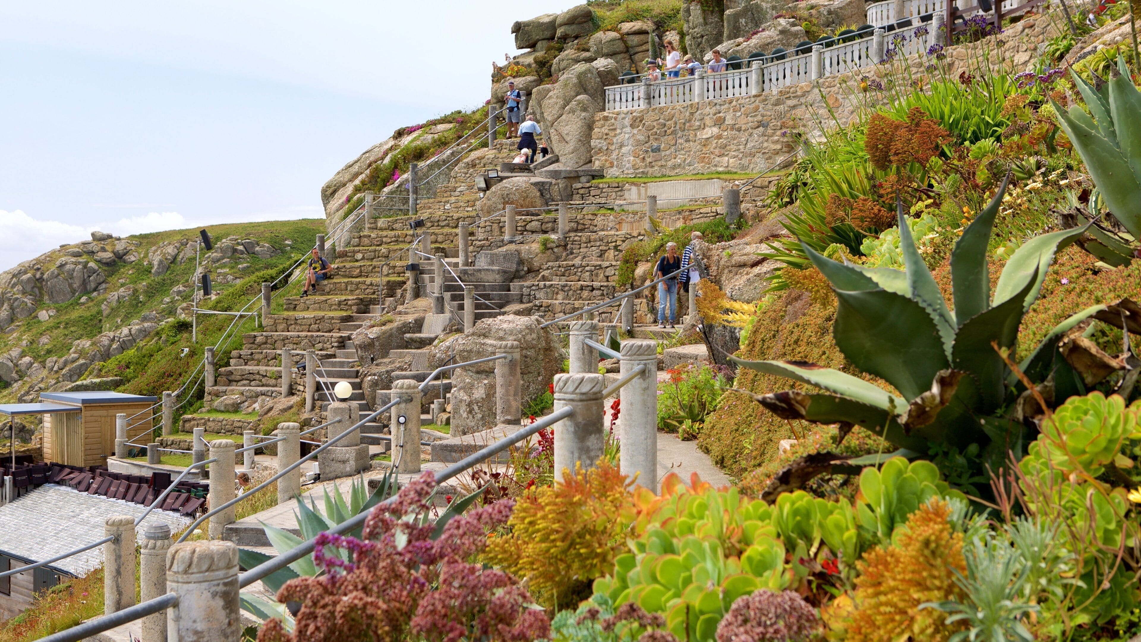 A stone staircase leading up a hill with people walking.