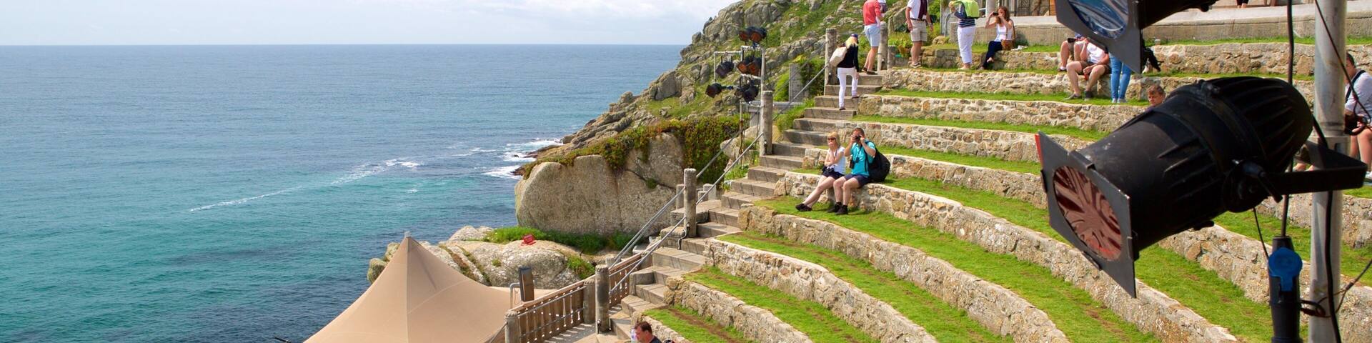 Terraced steps leading to a coastal area with a tent and people sitting and walking.