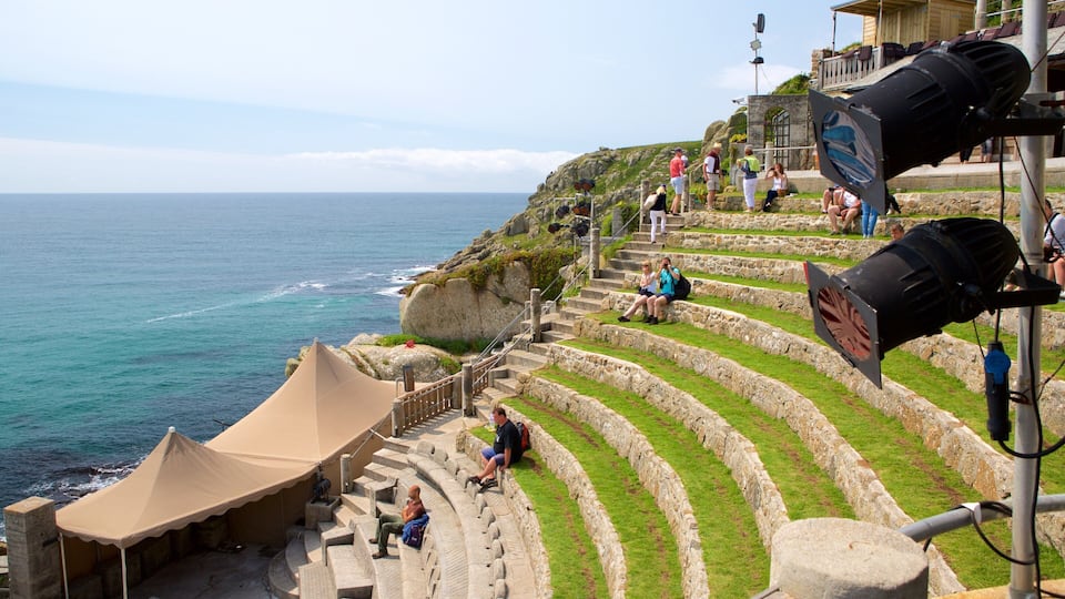 Terraced steps leading to a coastal area with a tent and people sitting and walking.