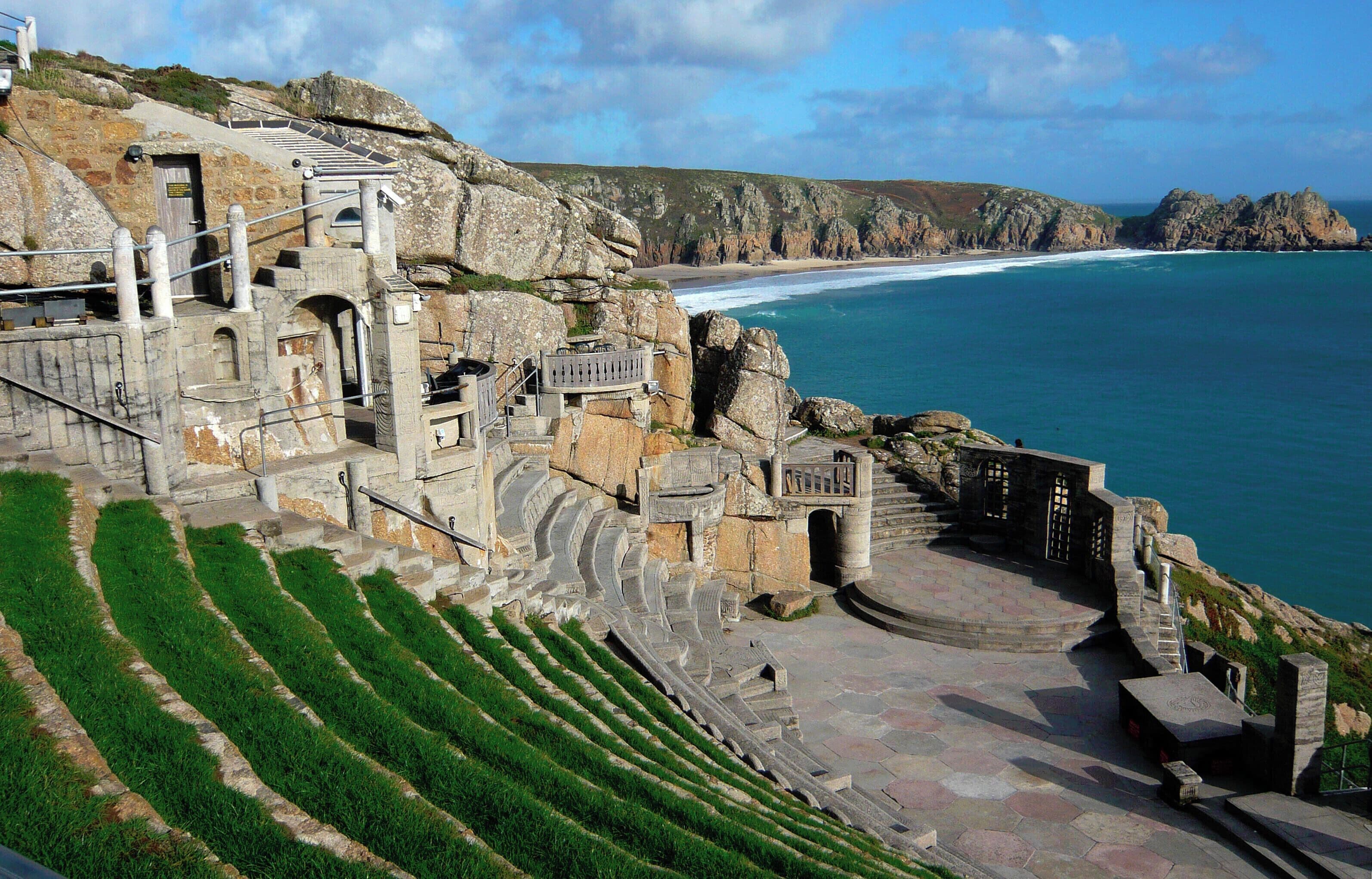 A coastal amphitheater with stone steps and a view of the ocean.