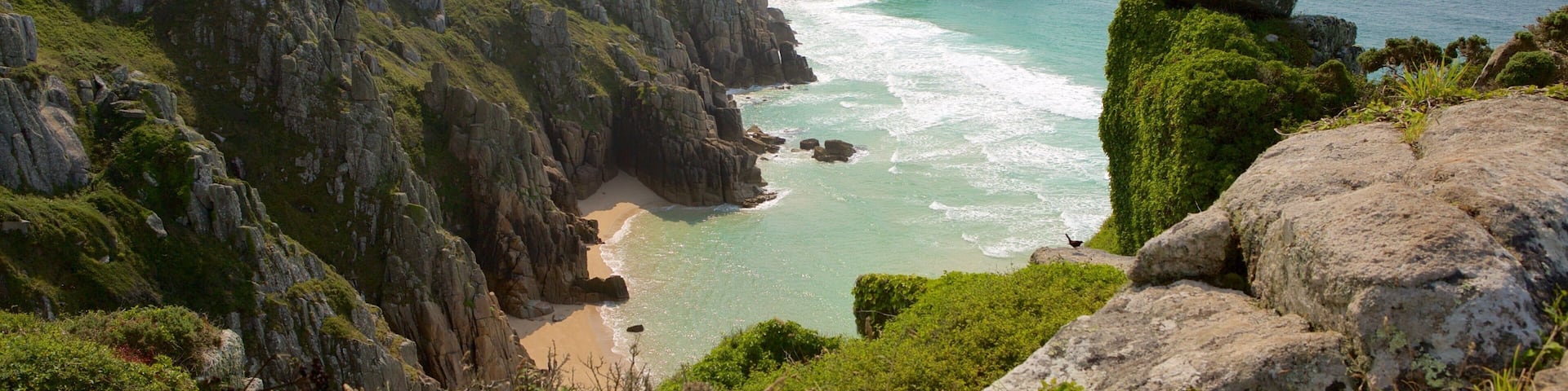 Logan\'s Rock which includes a sandy beach and landscape views