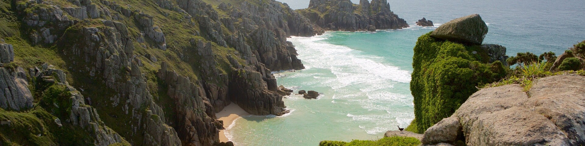 Logan\'s Rock which includes a sandy beach and landscape views