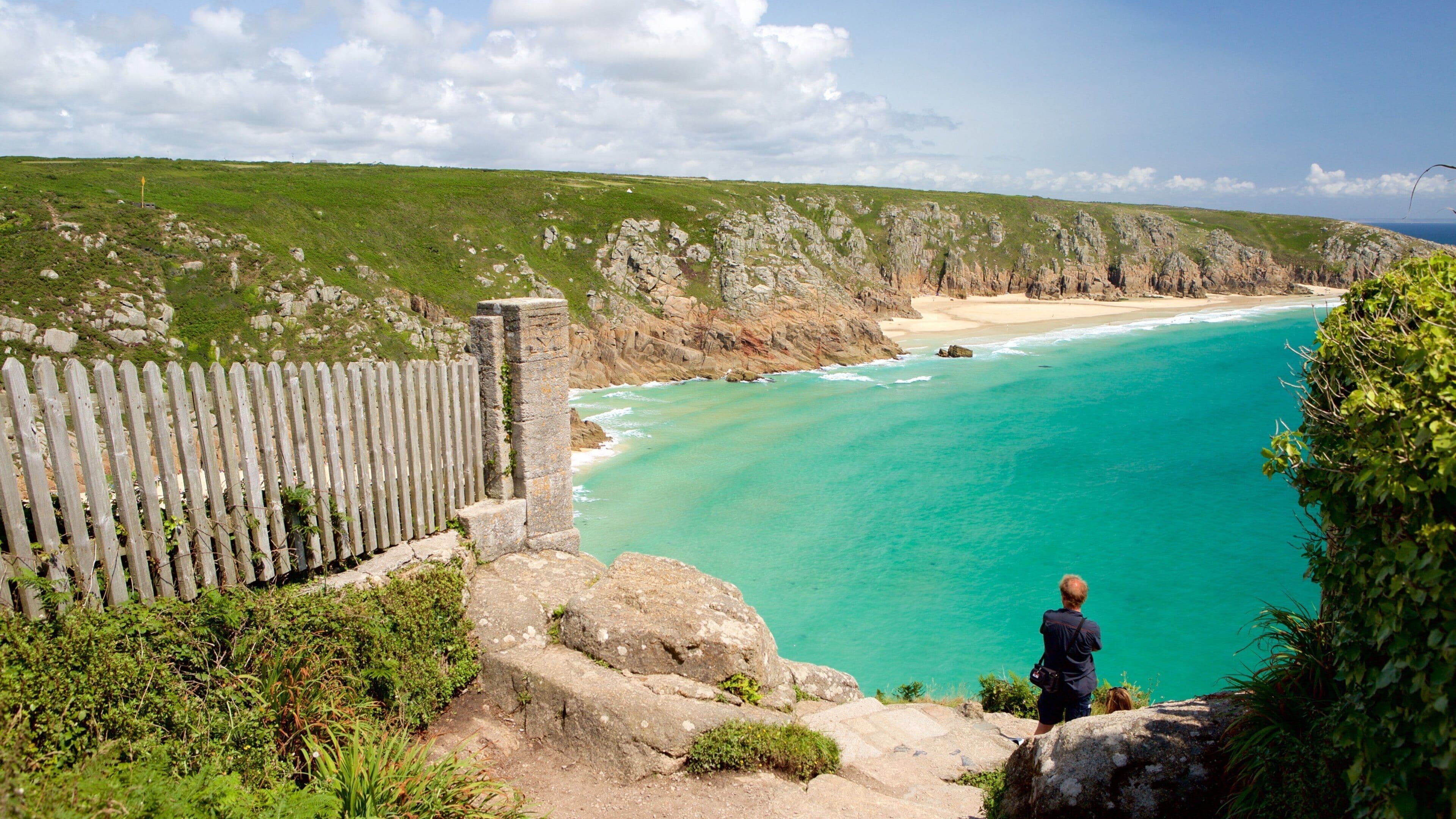 Porthcurno Beach showing views and rugged coastline as well as an individual male
