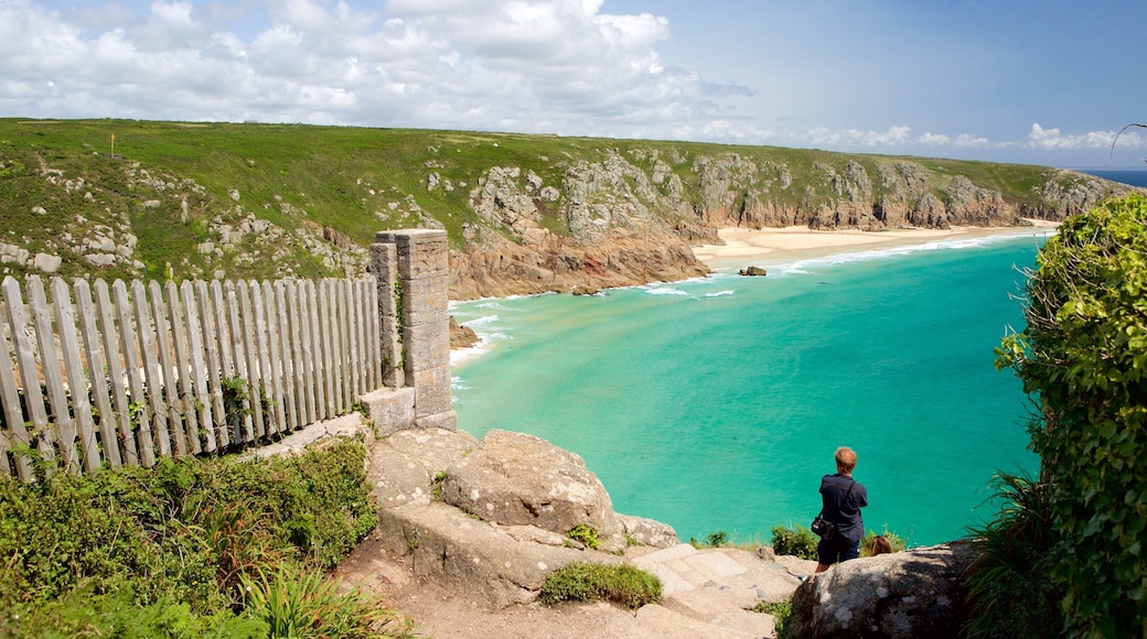 Porthcurno Beach showing views and rugged coastline as well as an individual male