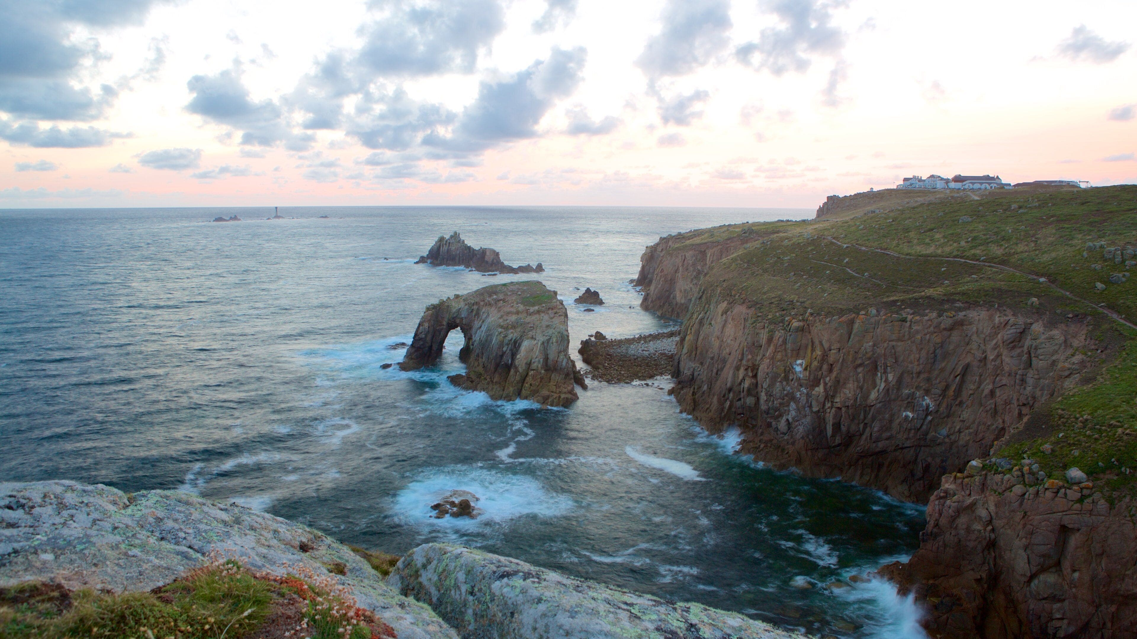 Land\'s End which includes rugged coastline, a sunset and landscape views