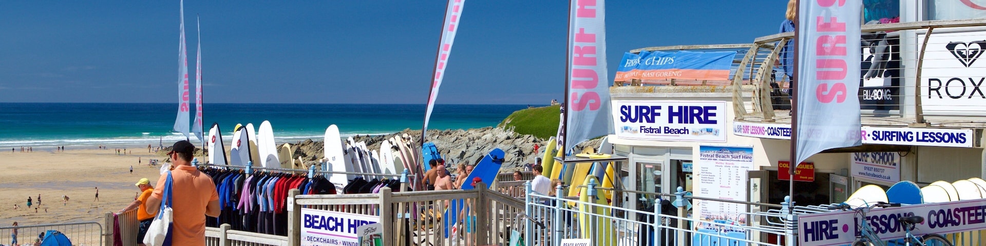 Fistral Beach which includes signage and a sandy beach as well as an individual male