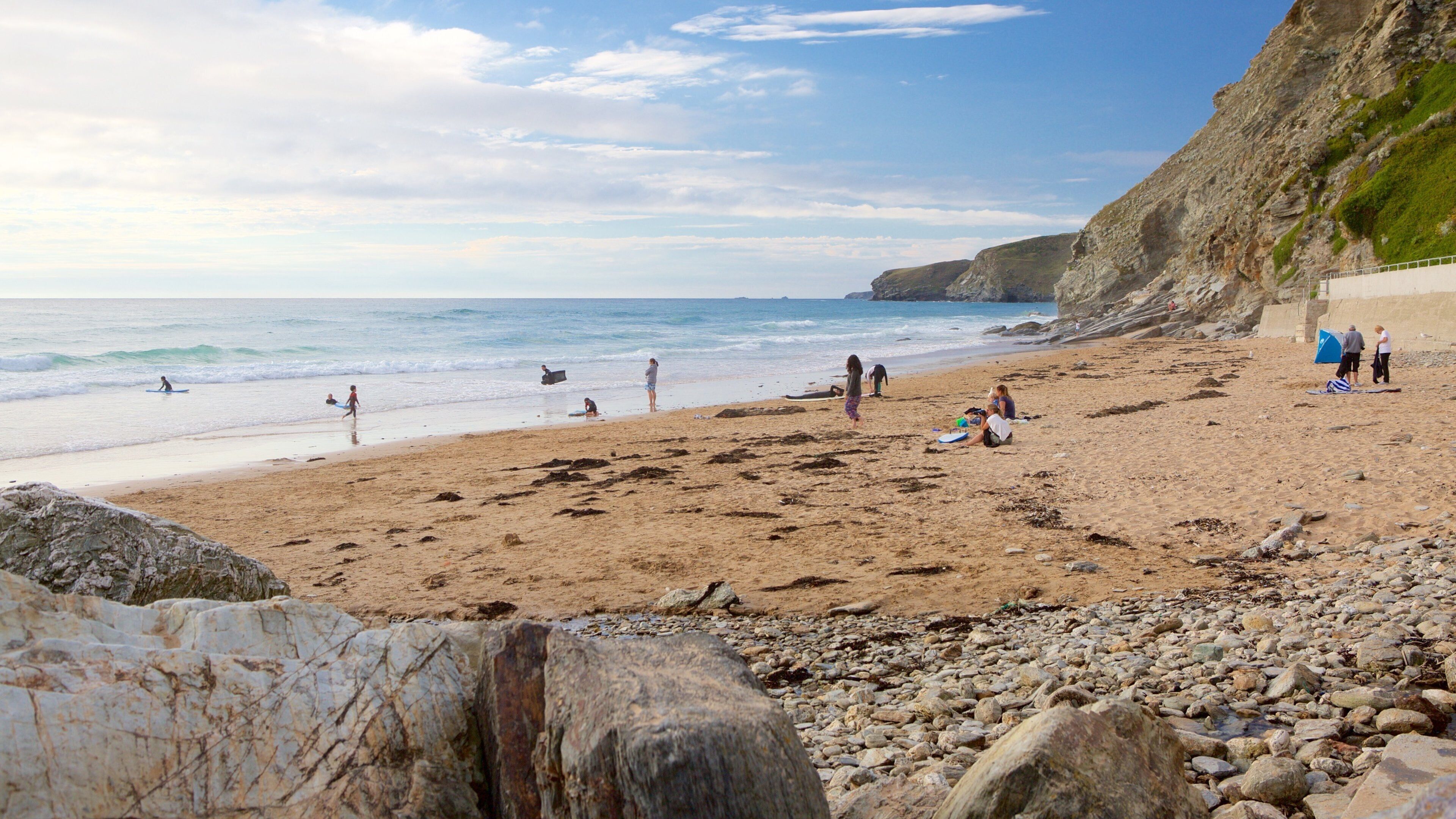 Watergate Bay Beach showing a sandy beach and rocky coastline