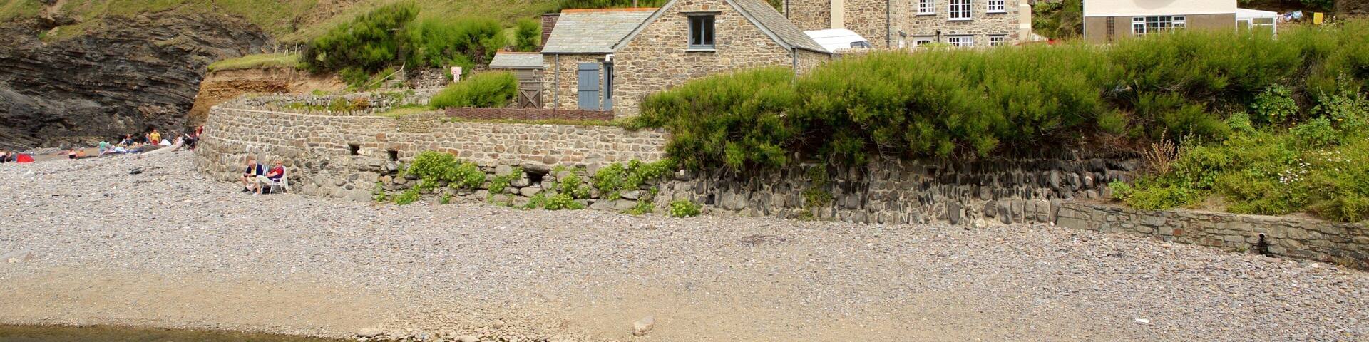 Crackington Haven featuring a pebble beach and a house
