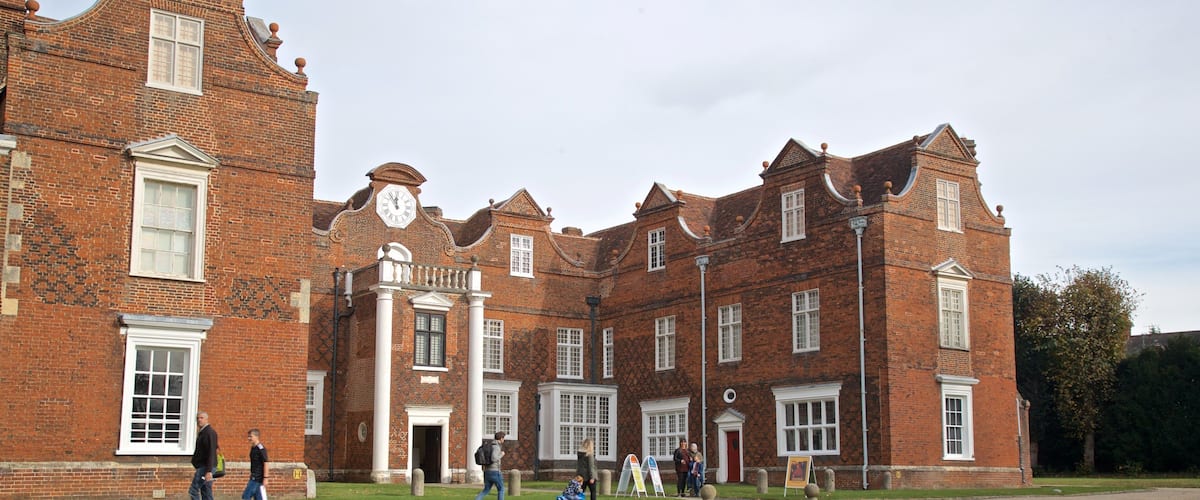 Christchurch Mansion featuring a house and heritage architecture as well as a small group of people