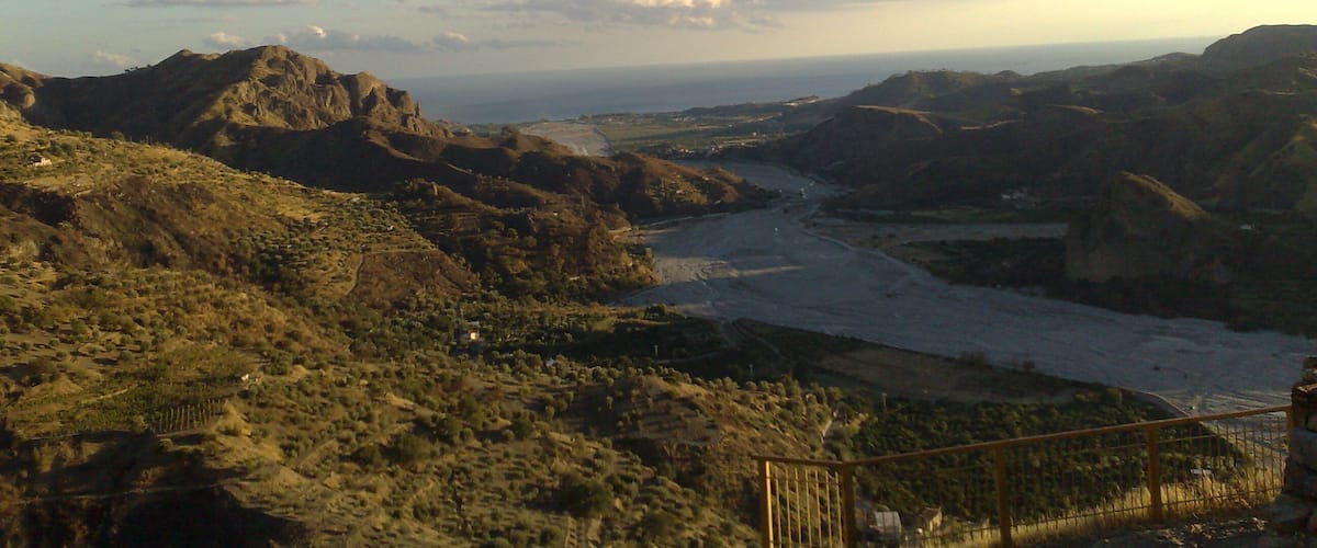 A mountainous landscape with a river flowing through a valley.