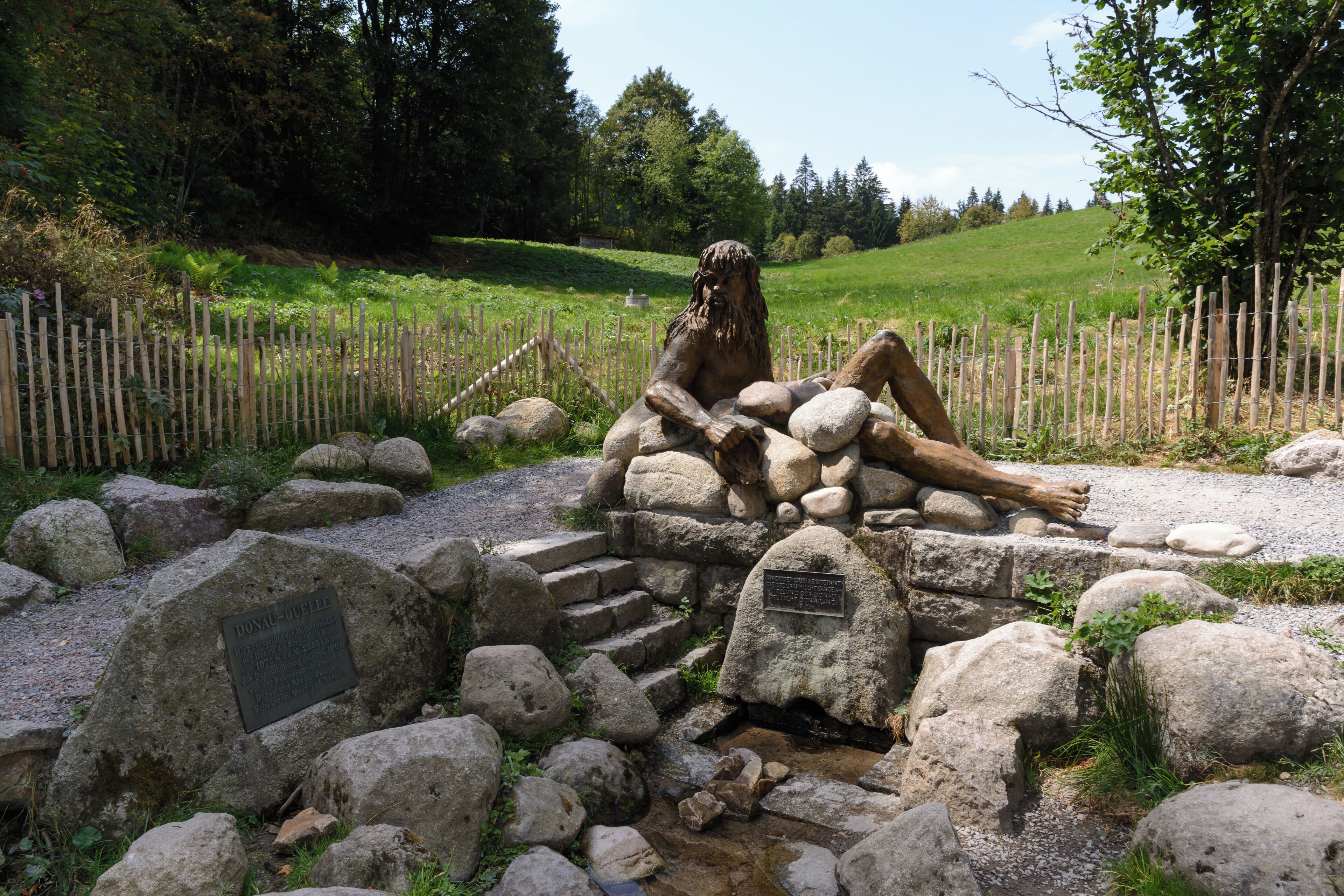 Source of the Breg, municipality of Furtwangen im Schwarzwald, Baden-Württemberg, Germany. This source is also called source of the Danube, as the Breg is the longer of the two formative streams of the Danube. Sculpture of Danuvius, god of Danube river, by Wolfgang Eckert, 2017.