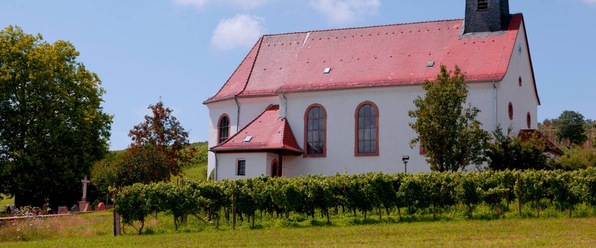 A church with a red roof and a bell tower.