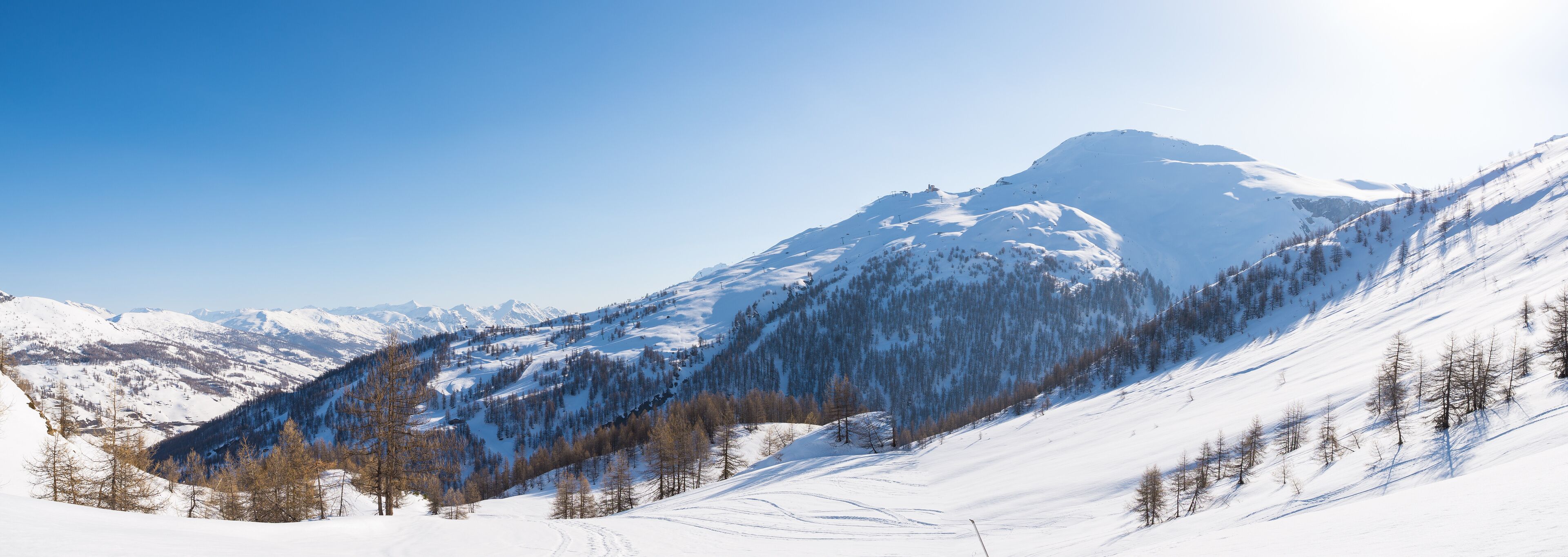 A snow-covered mountain range with clear skies.