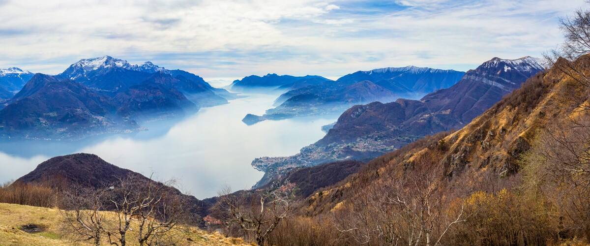 A mountainous landscape with a valley and a lake.