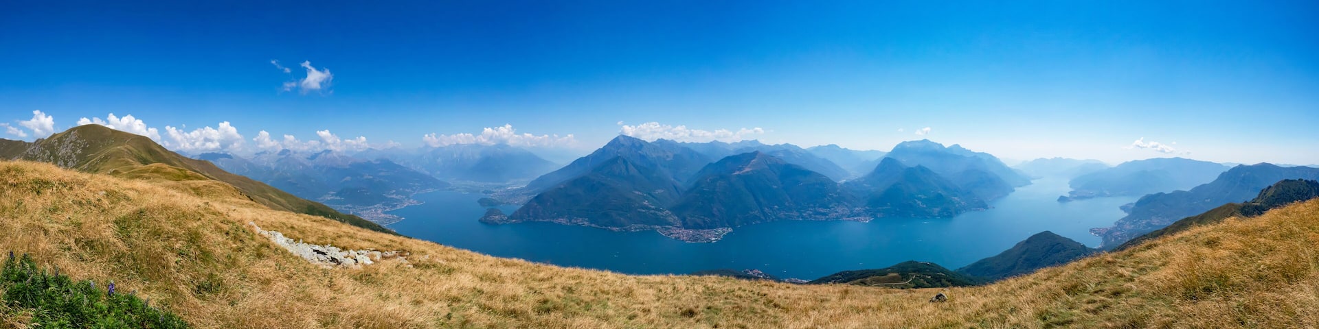 A mountainous landscape with a lake surrounded by peaks.