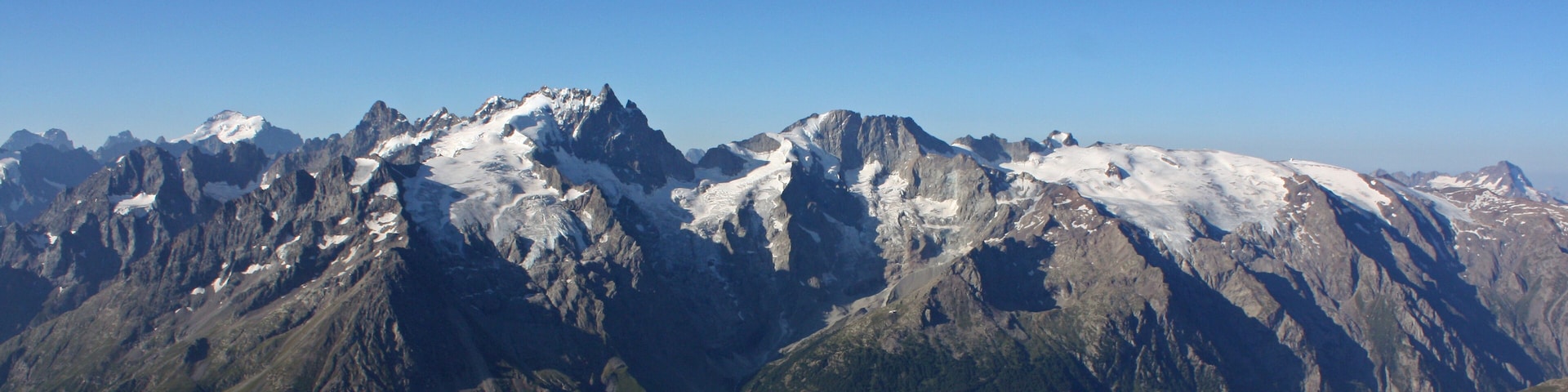 Una cordillera escarpada con picos nevados y pendientes pronunciadas.