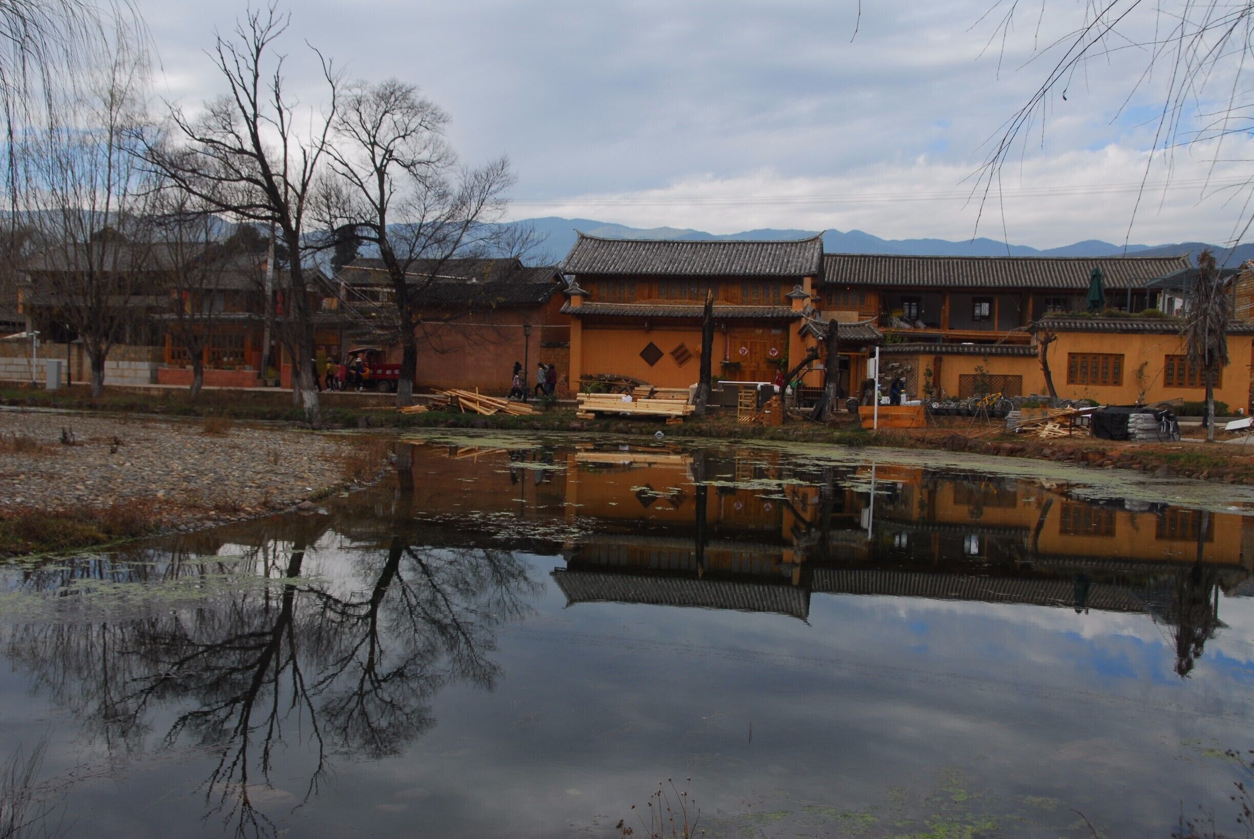 Reflection near Shaxi Old Town Back Gate - and nice park for children young and old to play in while watching peaceful life.