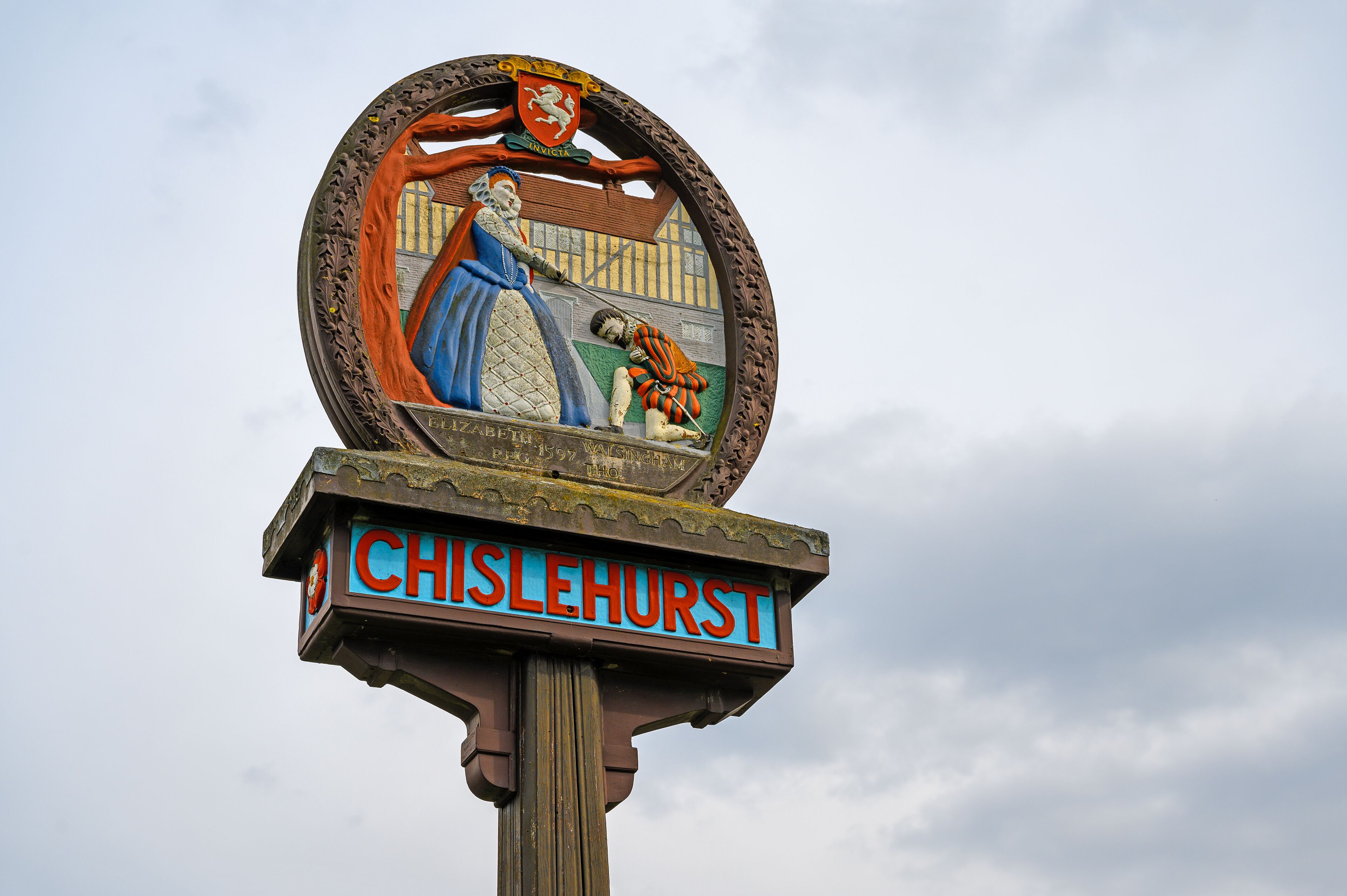 A historical sign with a coat of arms and the name 'CHISLEHURST'.