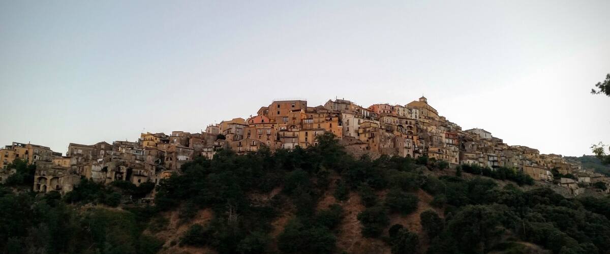 A densely packed hillside town with historic architecture.