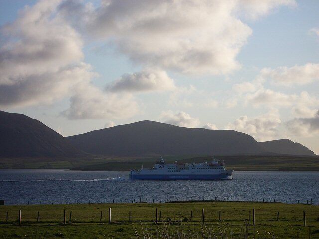 Northlink ferry in Scapa Flow. An evening view from Buxa towards Hoy with the ferry heading through Scapa Flow on its way to Stromness.
