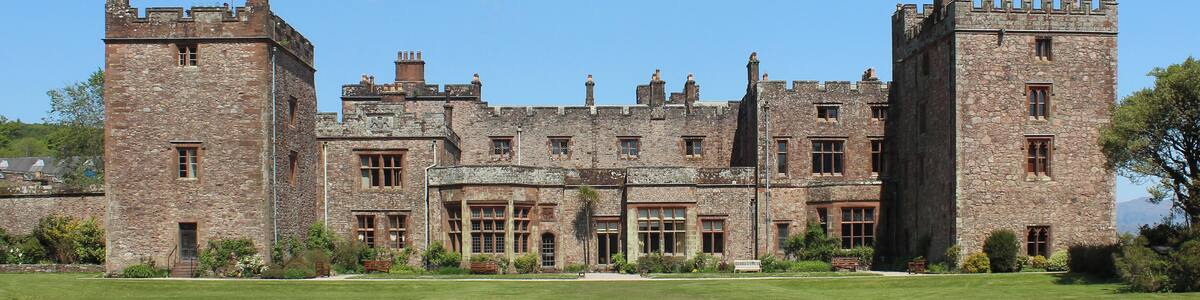 Muncaster Castle viewed from the south-west. The oldest parts of the castle are believed to have been built in the 14th century, possibly on the site of a Roman fort. It was extensively refurbished during the Victorian era.