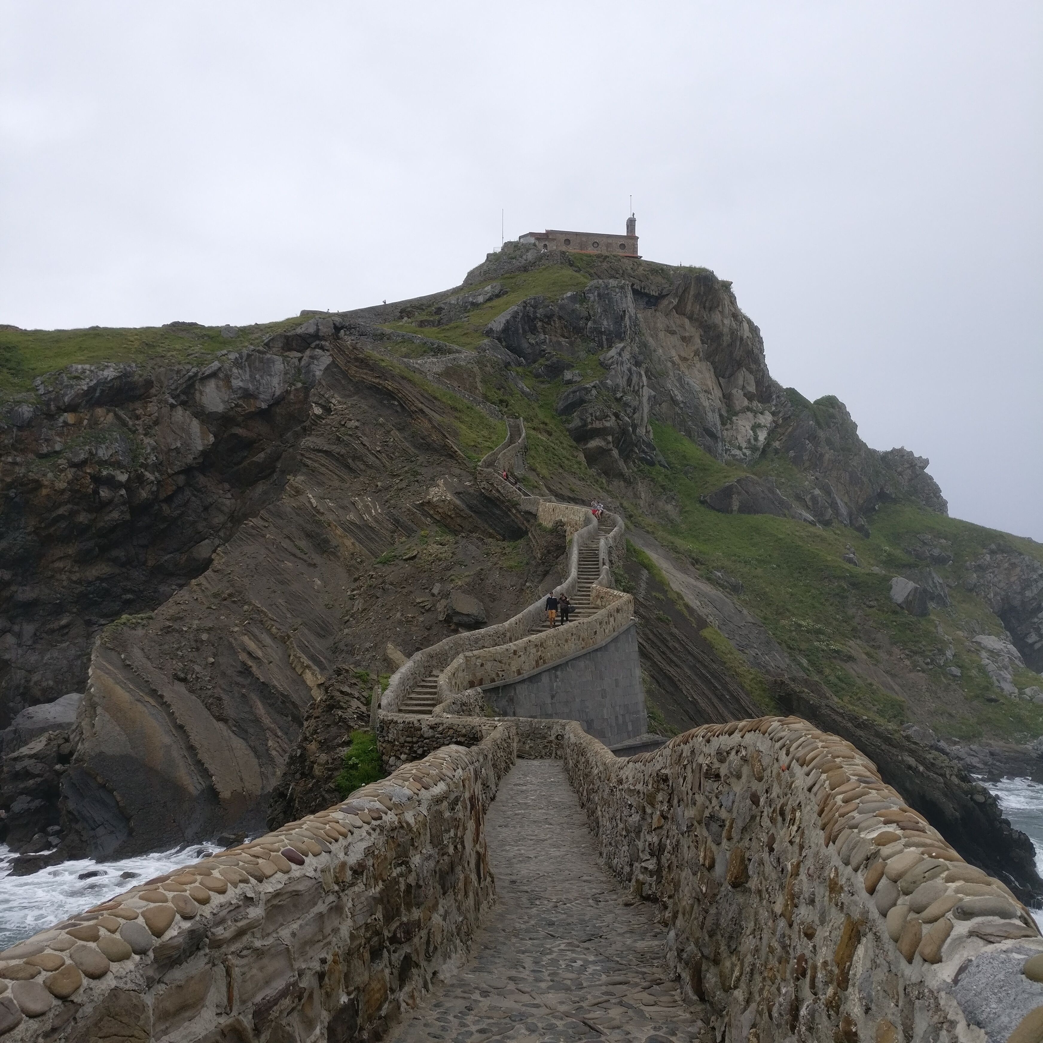Hidden on the northern Spanish coast in Basque Country lies this small island connected to the mainland by a man-made bridge. At the top of Gaztelugatxe sits a small church that dates back to the 10th century and is apparently dedicated to John the Baptist. This hidden gem and the small hike with the cool ocean air are totally worth the long and windy drive to get there. Additionally, this small island was used as a filming location for the Game of Thrones.

#LifeAtExpedia 
#myadventuresinSpain
#Spain