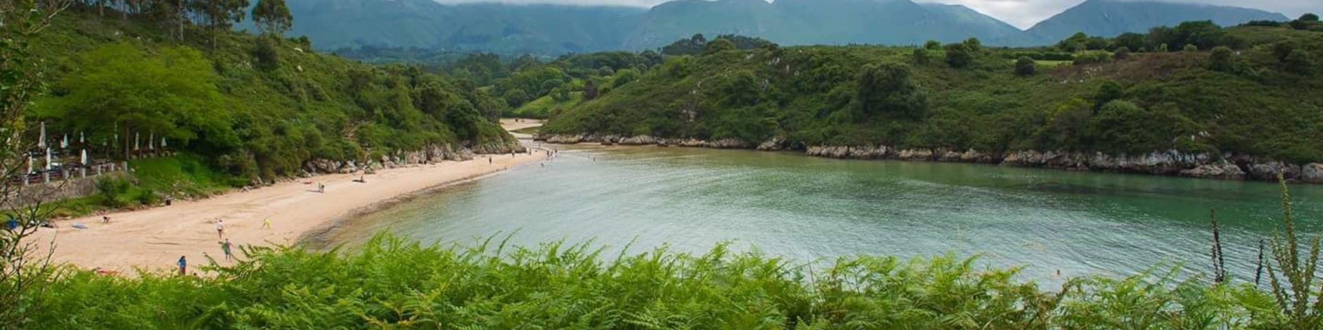 The stunning beach at Playa de Poo, Asturias, with the Pics de Europa in the distance.
