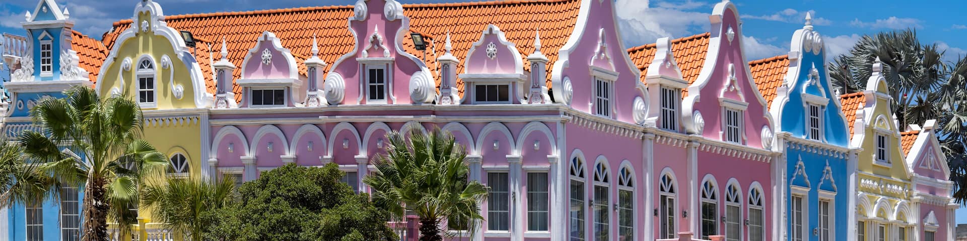 A colorful building with ornate architecture and a red-tiled roof.