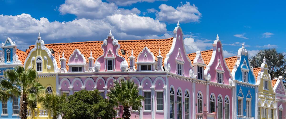 A colorful building with ornate architecture and a red-tiled roof.