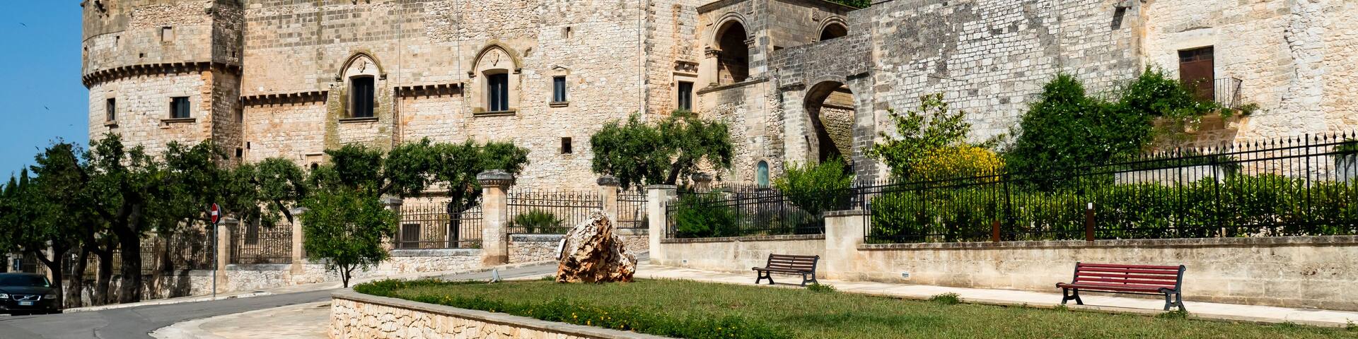 A historic stone fortress with a prominent tower and arched windows.