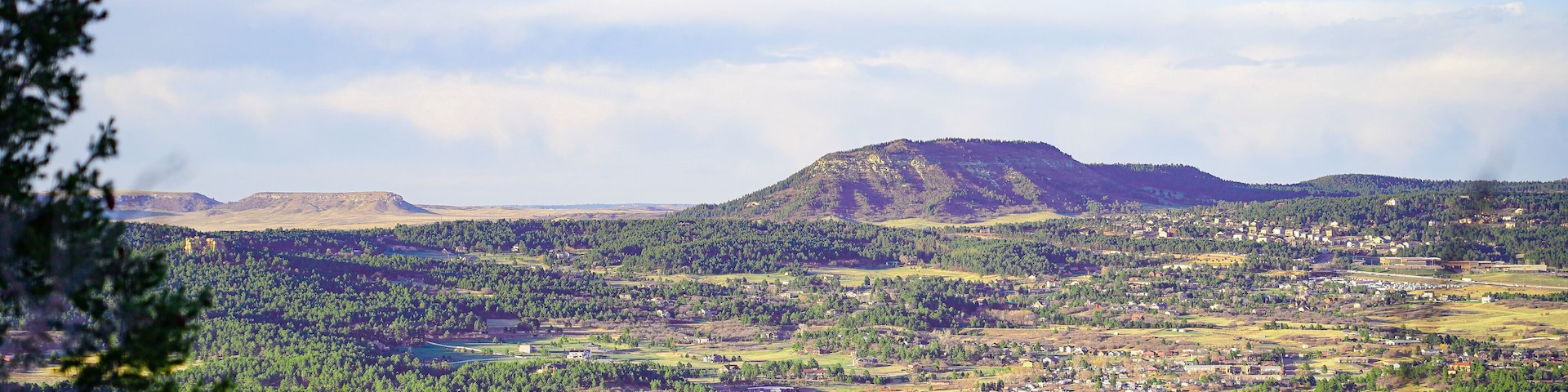 A mountainous landscape with a town in the valley.