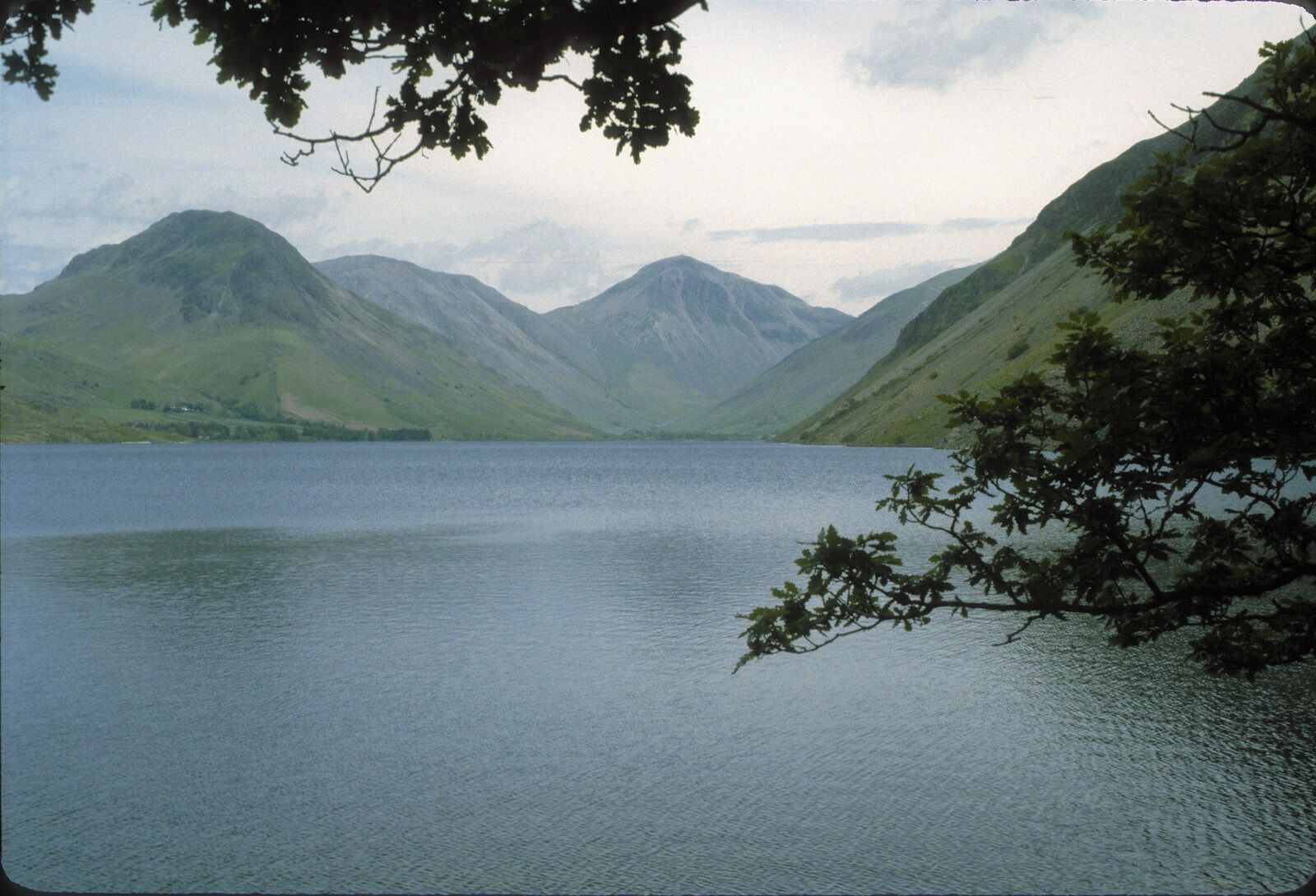 A calm lake surrounded by mountains.