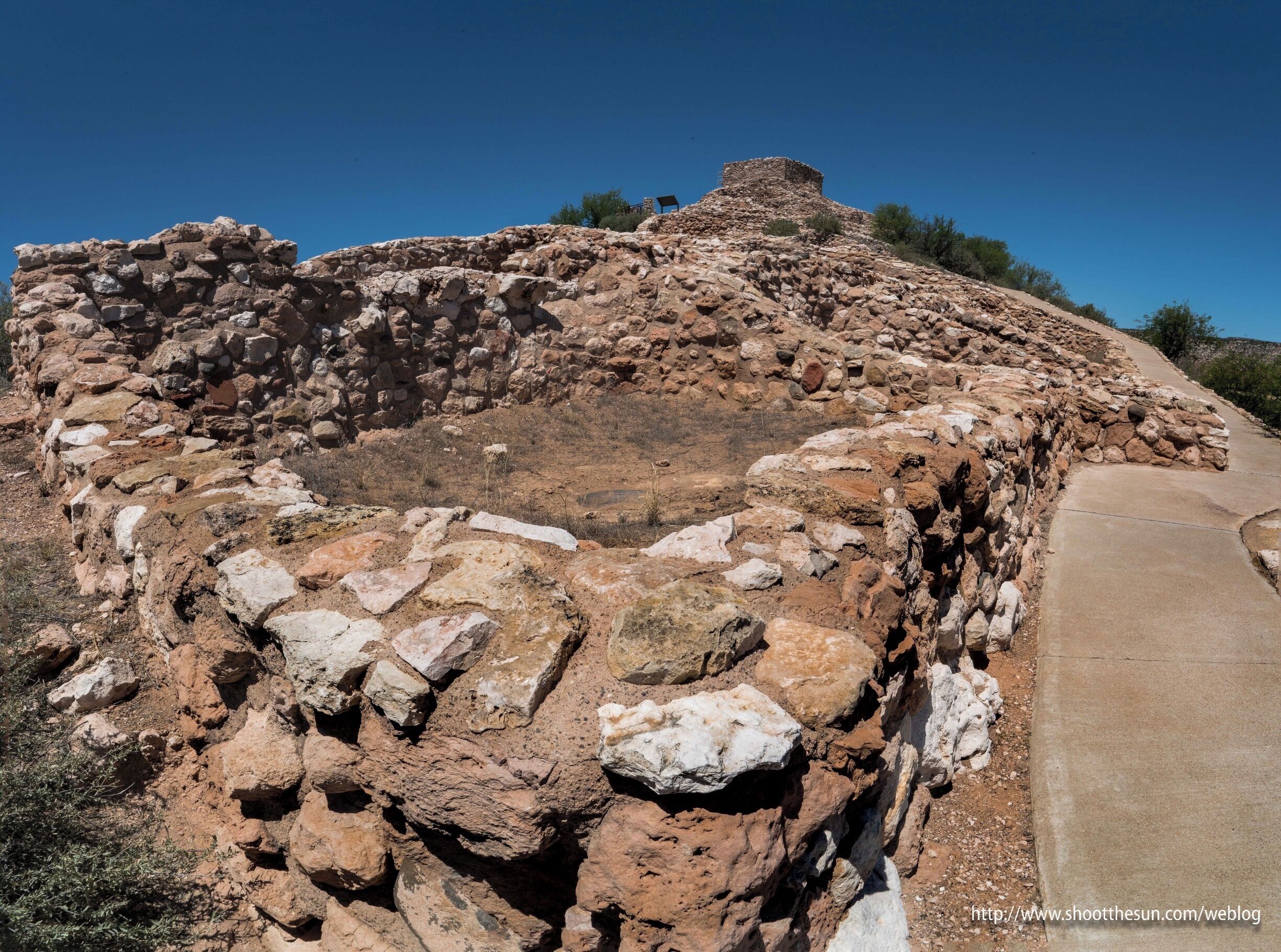 You wander around the desert outside Sedona and you're constantly amazed by all the natural formations poking up and undulating out of the landscape.  Then you come upon Tuzigoot, and your eyes fly cartoon-like out of your head.

Because there, on the top of a hill sits a nine-hundred year old chunk of stone put entirely there by people.  The structure contains the remnants of some 110 rooms and spans an area large enough so that a lot of the tourists pop their heads around and say "I'm good," and just head back to the visitor's center.

It's not a fair comparison, but while Europe was suffering a long, dark period of its civilization, here in the Americas, populations were thriving, and new technology of all kinds was being employed to accommodate them.

Here in the Verde River Valley, a group of people later named Sinaguan (without water), put together workable communities in some of the harshest conditions on the planet.  They were all to be abandoned later -- by some accounts because of extended droughts -- but what they did here is nothing short of miraculous.

I have plenty more to show from this site, but for now, take a gander at this spreading honeycomb of brick and clay, still standing (though patched and repaired by modern caretakers) nearly a thousand years after its construction.

And renew your appreciation for the native peoples of this continent.  They did not simply survive.  They built and fortified and settled and grew.  You may look for a culture gap between the new world and the old if you so choose.

But come to this place and you will have a hard time finding it.


https://en.wikipedia.org/wiki/Tuzigoot_National_Monument