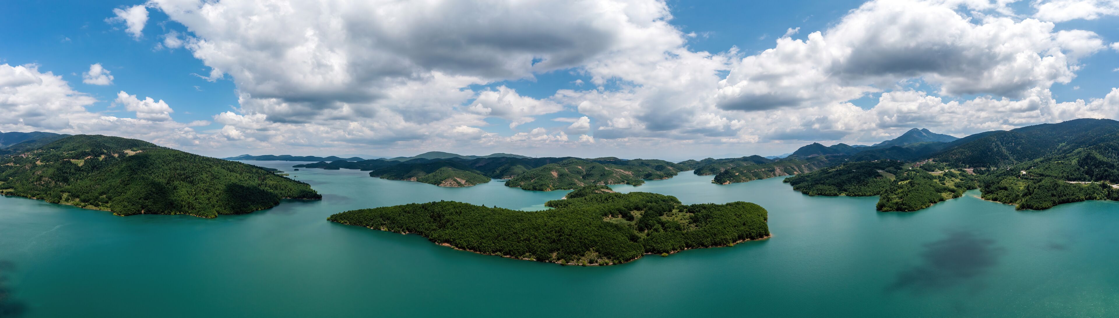 Plastiras Lake, Greece panoramic aerial view, blue cloudy sky. Artificial lake in Karditsa, Thessaly