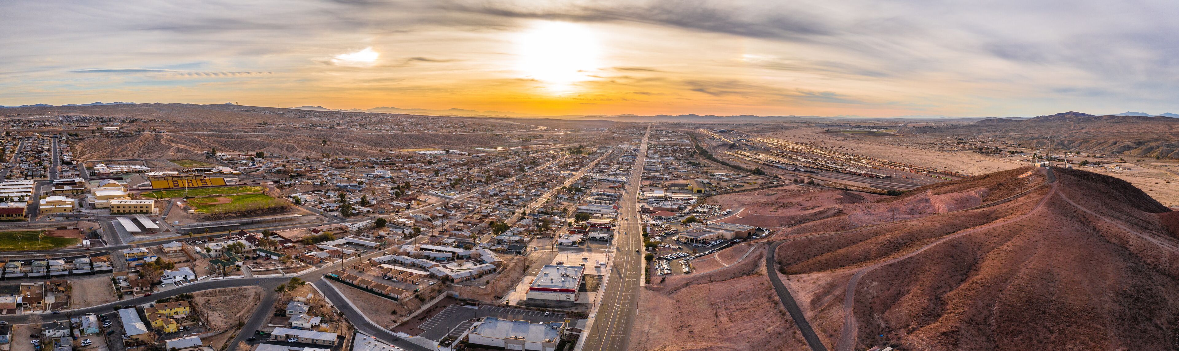 Aerial view of Barstow community a residential city of homes and commercial property community Mojave desert California USA at sunset