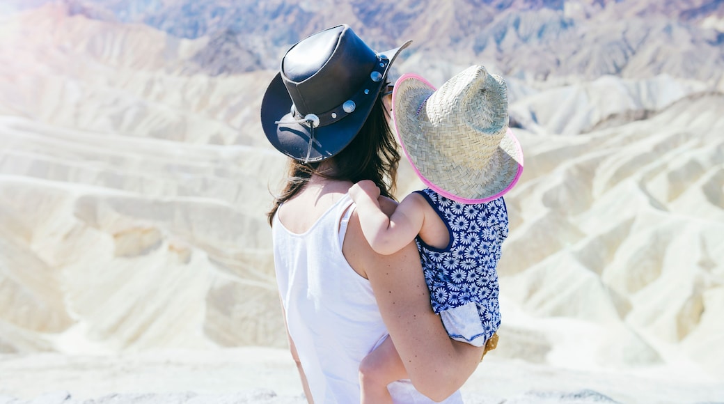 USA, California, Death Valley National Park, Twenty Mule Team Canyon, back view of mother and baby girl