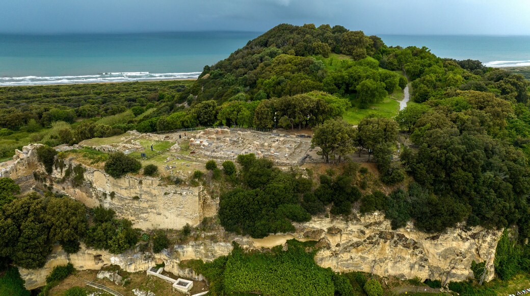Aerial view of the archaeological excavations of Cuma, in the province of Naples, Campania, Italy. On the hill are the remains of the ancient city of Cumae, one of the oldest Greek colonies in Italy.