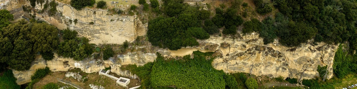 Aerial view of the archaeological excavations of Cuma, in the province of Naples, Campania, Italy. On the hill are the remains of the ancient city of Cumae, one of the oldest Greek colonies in Italy.