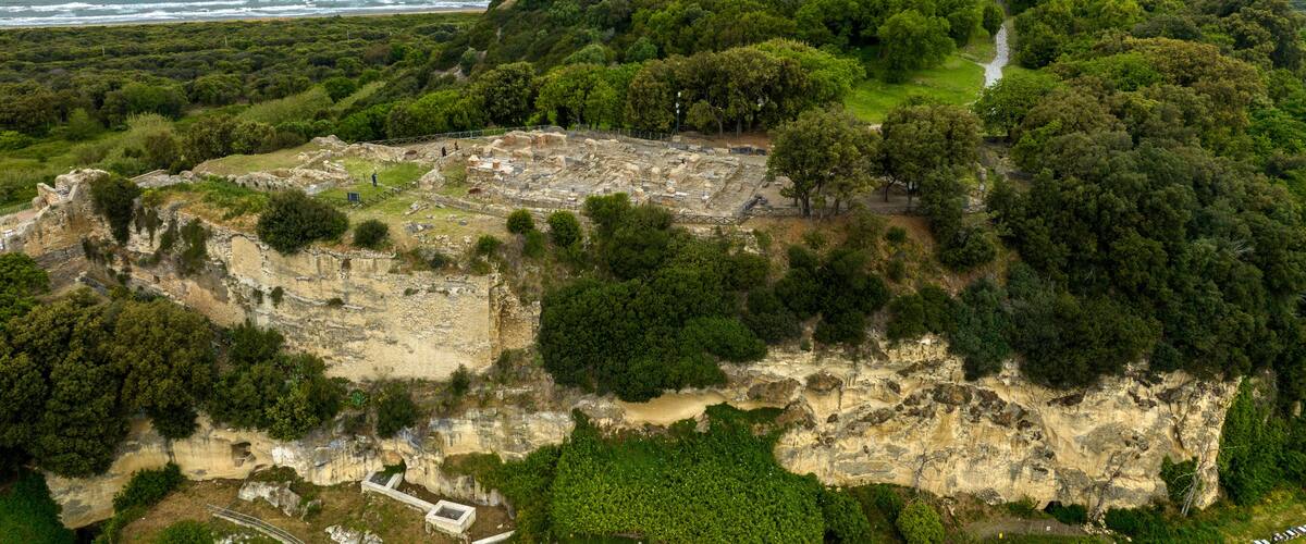Aerial view of the archaeological excavations of Cuma, in the province of Naples, Campania, Italy. On the hill are the remains of the ancient city of Cumae, one of the oldest Greek colonies in Italy.