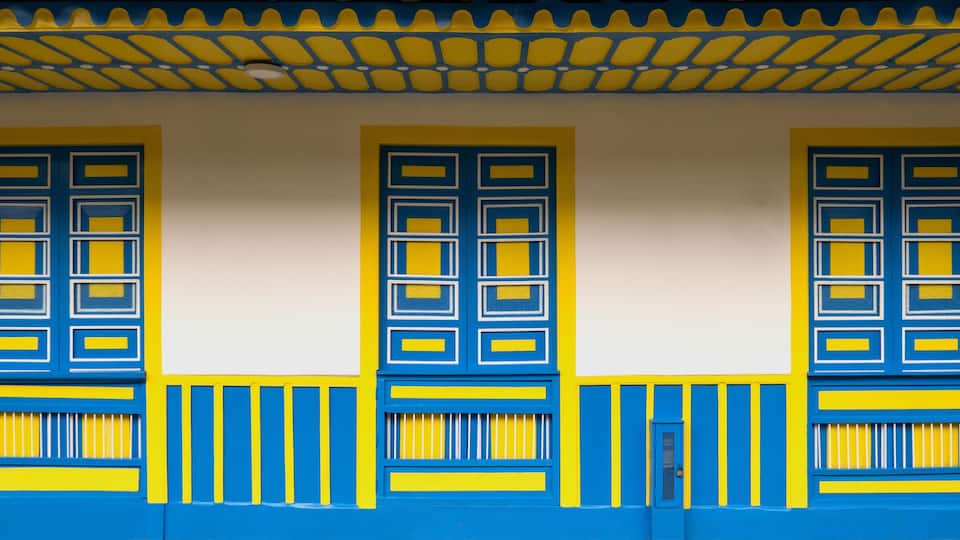 Traditional architecture of the coffee region, with three windows and base in blue and yellow colors, in Filandia Colombia,