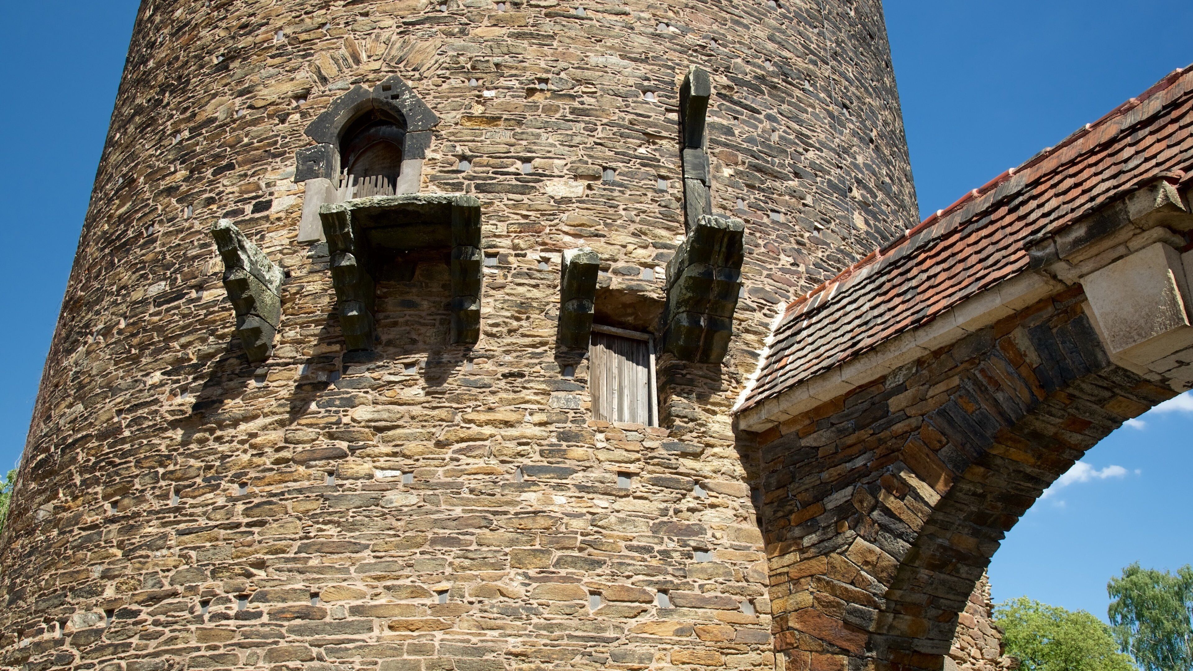 A stone tower with a wooden door and a small window.