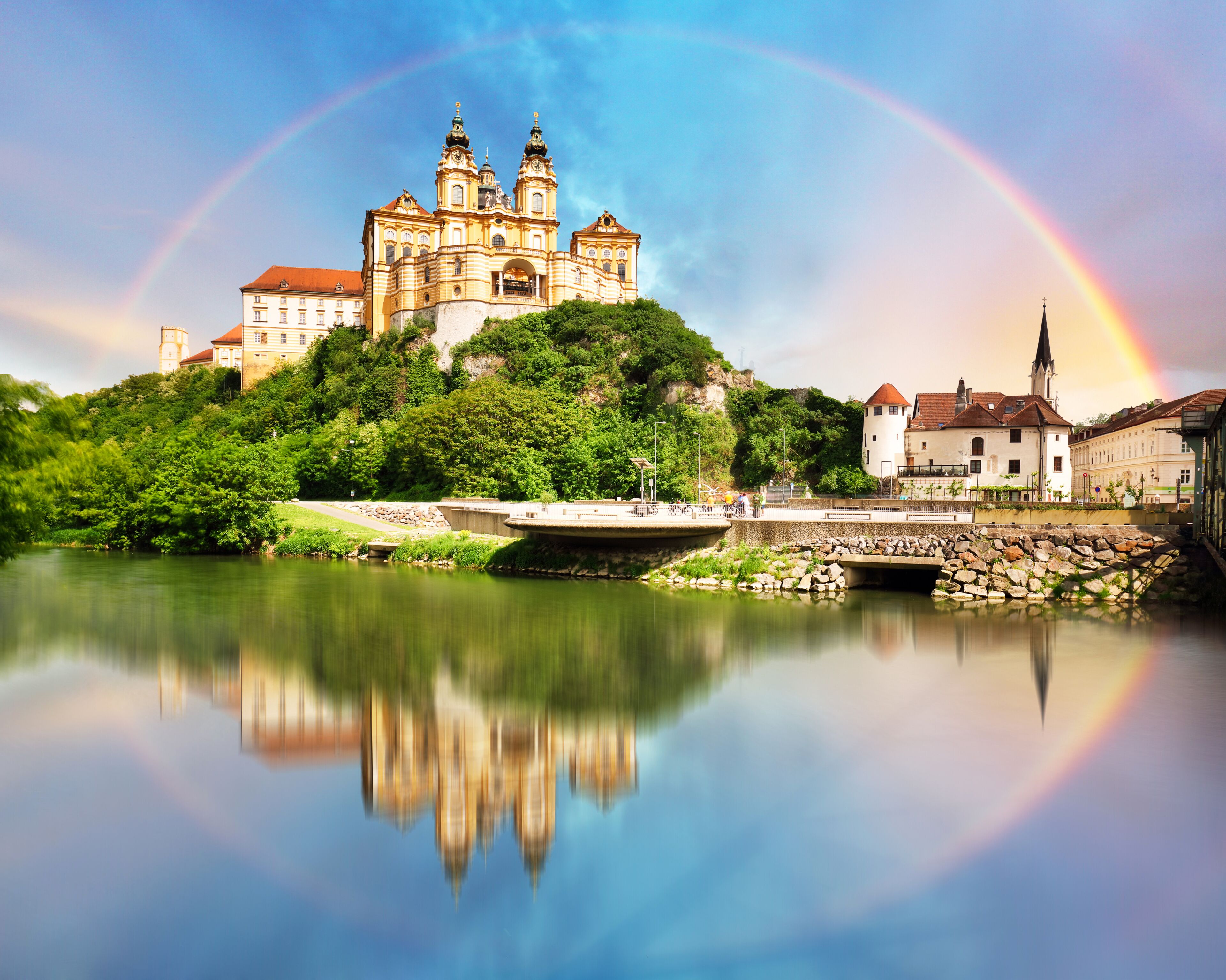 Austria - Rainbow over Melk Abbey with reflection in water, Wachau
