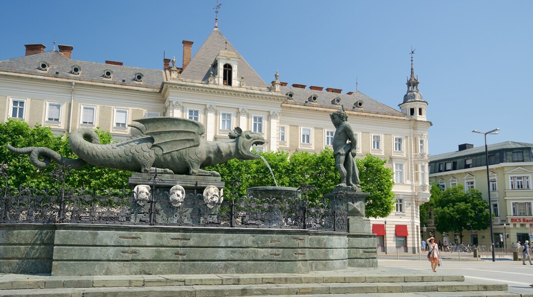 New Square showing a fountain, heritage elements and a statue or sculpture