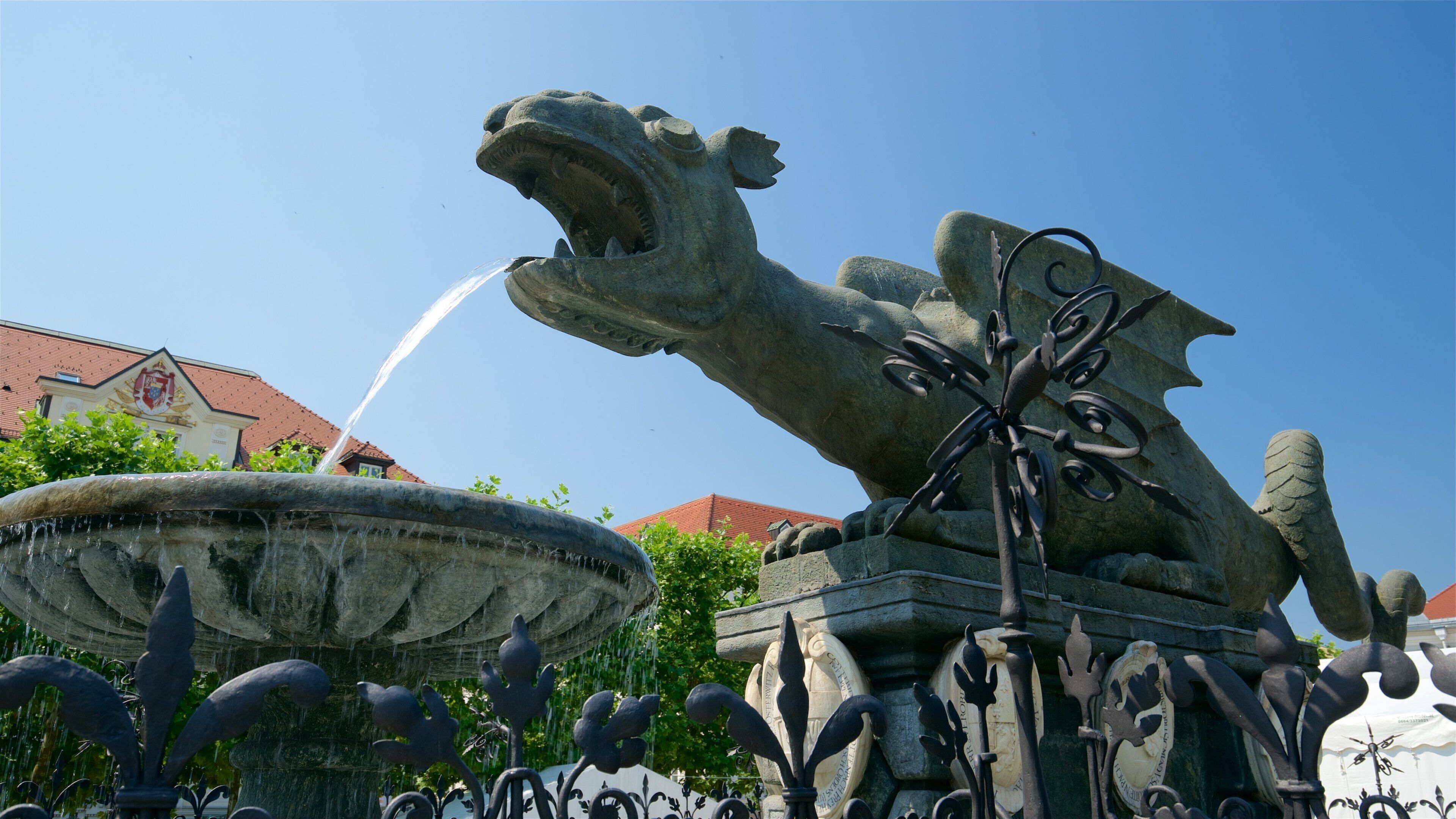 New Square featuring a fountain and a statue or sculpture