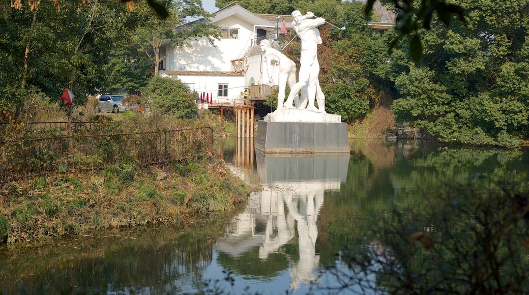 Hangzhou Botanical Garden featuring a statue or sculpture and a pond