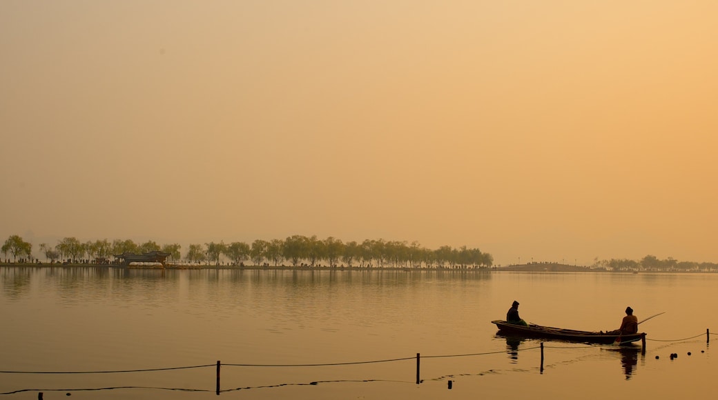 Broken Bridge which includes a sunset, a lake or waterhole and kayaking or canoeing