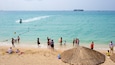 Dadongdai Beach which includes general coastal views and a beach as well as a large group of people