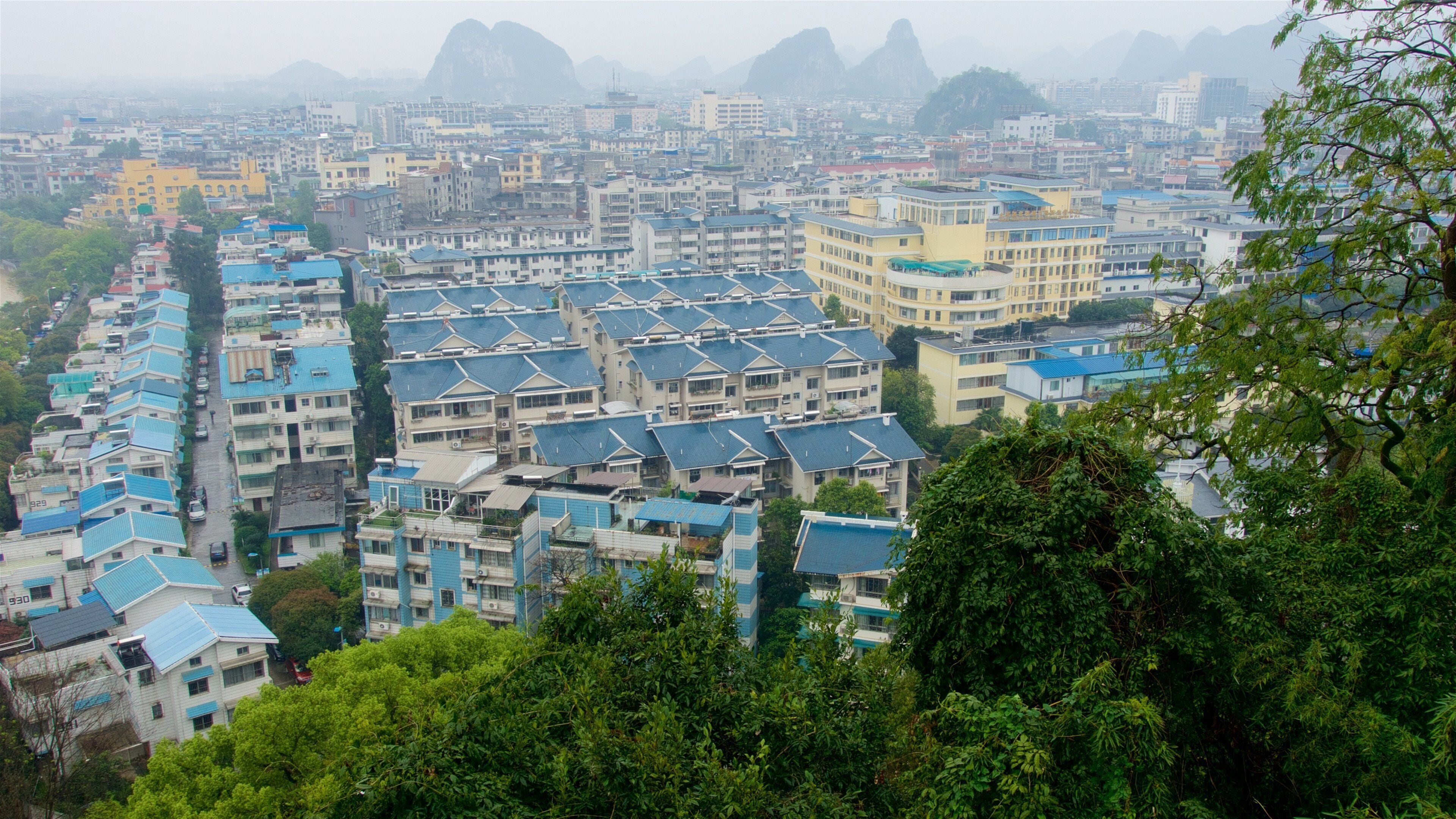 Elephant Trunk Hill which includes landscape views, a city and mist or fog